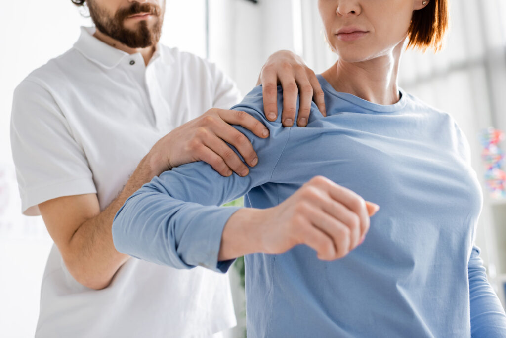 Chiropractor examining a patient’s shoulder during chiropractic treatment at iGood Health Centre in Richmond Hill.