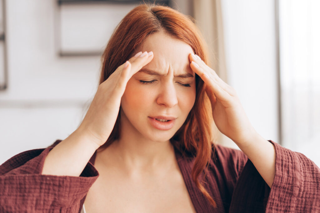 Woman experiencing headache and migraine symptoms at home before seeking care at iGood Health Centre in Richmond Hill