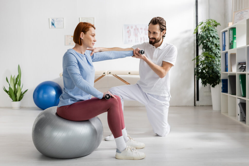 Physiotherapist guiding a patient through a shoulder rehabilitation exercise at iGood Health Centre in Richmond Hill.